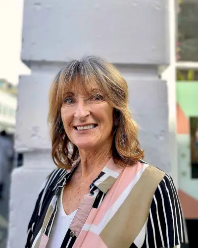 Medium Shaggy Cut for Thick Hair a lady in her 60s