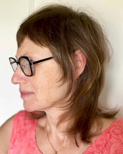 Shoulder-Length Hairstyle with Glasses for ladies in their sixties