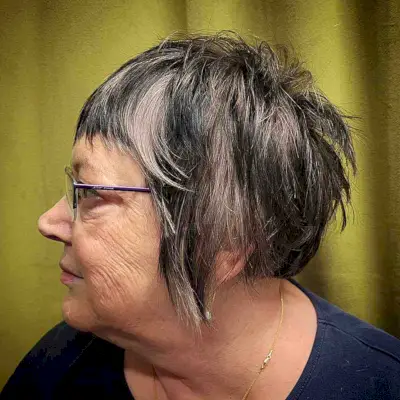 Short Shaggy Bob with Choppy Bangs and Layers for 50-Year-Old Women