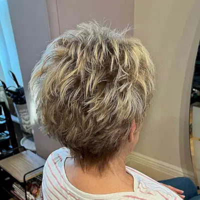 Dark-Rooted Blonde Feathery and Choppy Pixie for Mature Women Aged Sixty