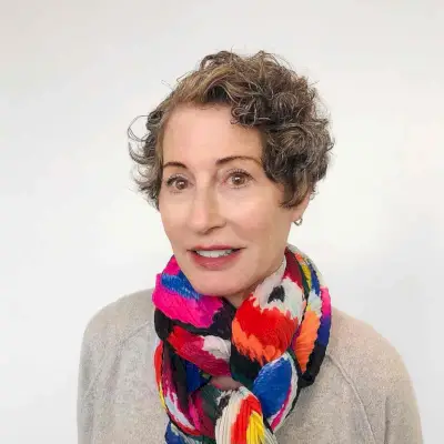 extra short curly hairstyle with a deep side part