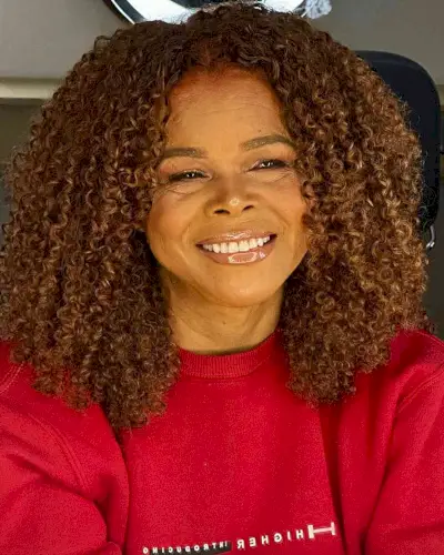Shoulder-Grazing Layered Curly Cut with Middle Part for Black Women Over 50