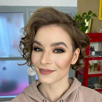 Voluminous Edgy Short Hair with a Deep Side Part and Brunette Waves