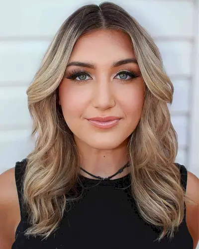 Rooted Blonde Hair with Classic Middle Part Waves for Prom Down Hairstyle