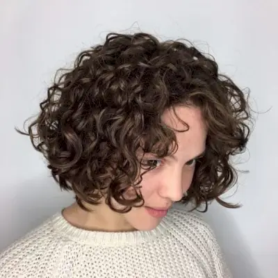 textured short bob permed hair with bangs