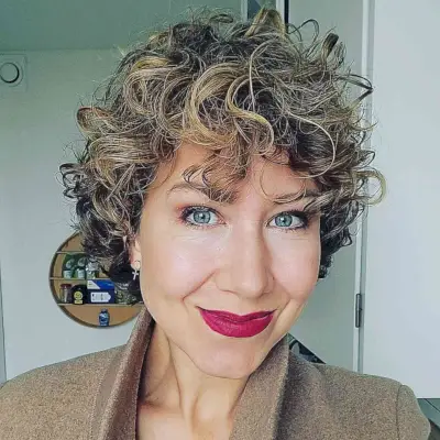 Short Blonde Highlighted Wispy Curls with Fringe