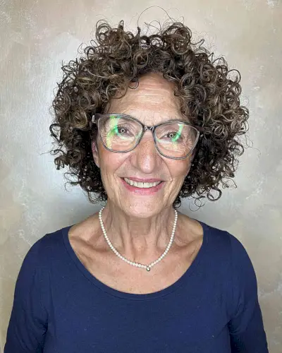 Curly cut with bangs for women over 50