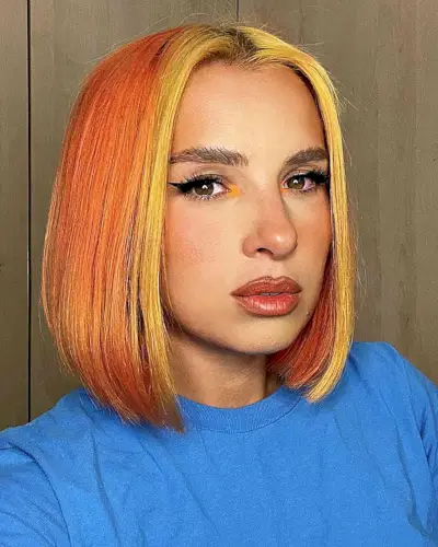 Above the Shoulder Sleek Orange Bob with a Yellow Money Piece