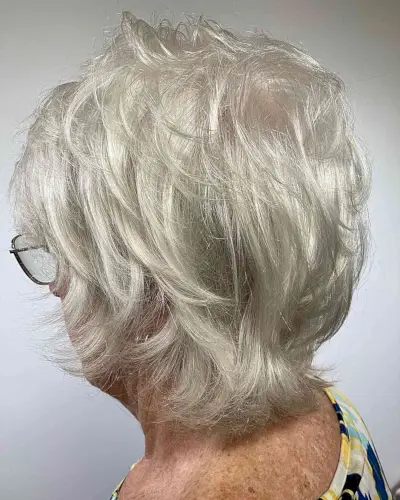Neck-Grazing Gray Feathered Choppy Short Haircut for Women turning 60