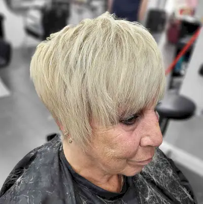 Cheek-length Textured Pixie with Choppy Layers and Bangs for 60-year-olds