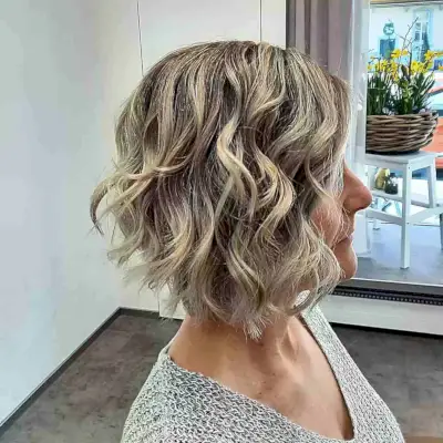 Neck-Length Rooted Blonde Wavy Choppy Bob for 60-year-olds