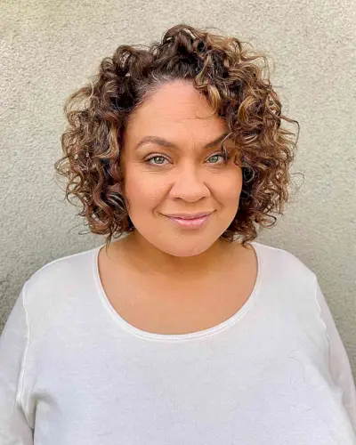 Short Side-Parted Curly Bob Cut for women with large foreheads and prominent cheeks