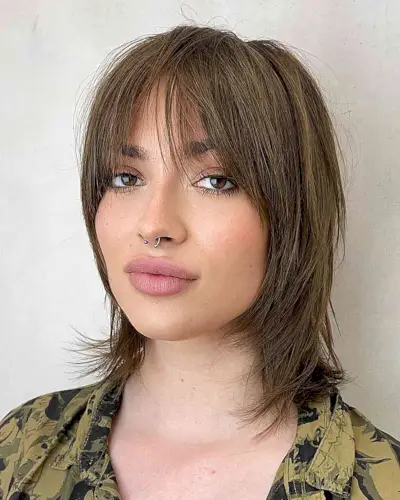 Wispy Bangs on a Brunette Wolf Cut for women with short straight hair
