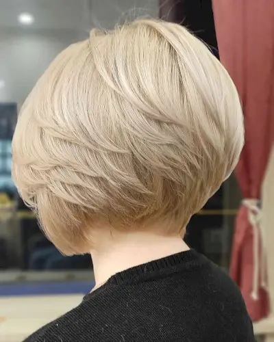 Straight Short Feathered Bob Cut with layers on blonde hair cut at the nape