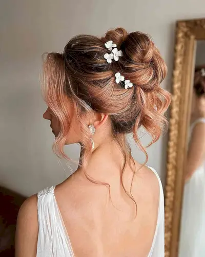Fancy Loose Updo in a Bun with Floral Pins with Face-Framing Tendrils