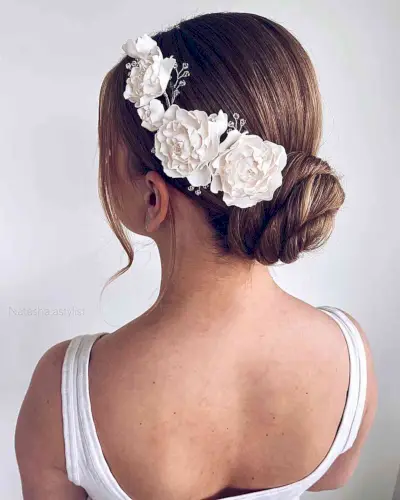 Simple and Modern Updo with Flowers for a Wedding