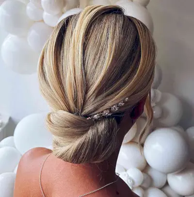 Polished low chignon hairstyle for wedding