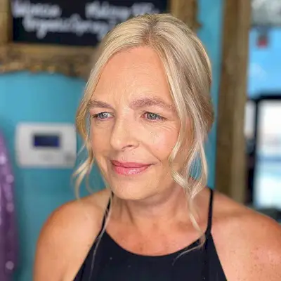 Easy Low Twisted Bun with Face-Framing Pieces for Older Mothers of the Groom