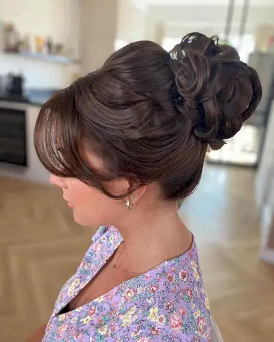 Bouffant Bun Updo with Bangs for Bridal Guests