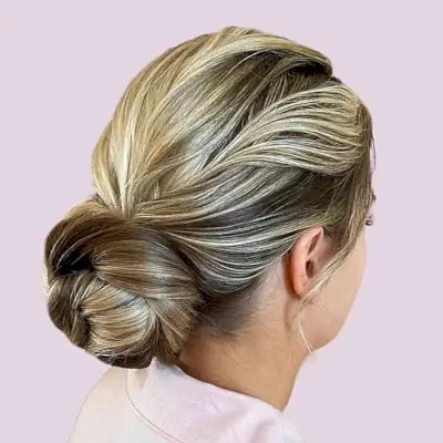 Brown-Blonde Low Textured Bun for Wedding Guest Hair Ideas