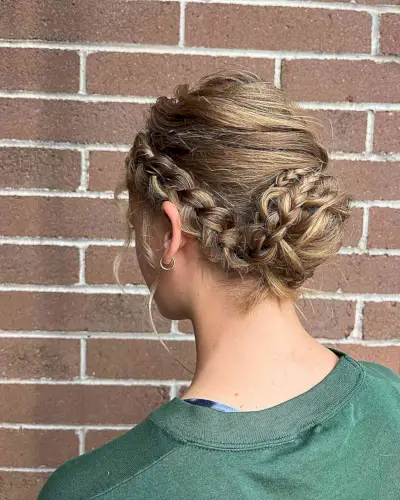 Loose Low Bun with Side Braids for Wedding Attendees