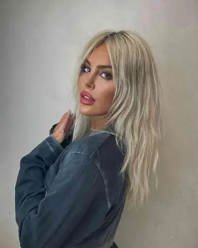 Trendy Layered Wolf Cut on women with longer hair and a middle part