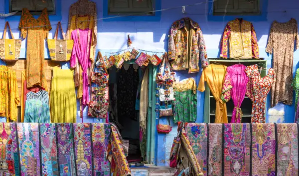 A market stall in India with fabrics and clothes and other items on sale for the Diwali festival