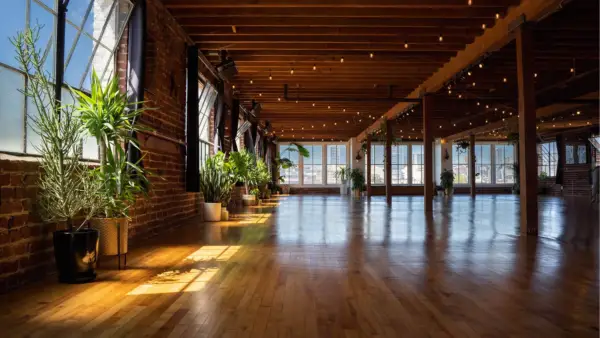 Interior shot of the wood floors and many windows of Haum yoga studio in San Francisco