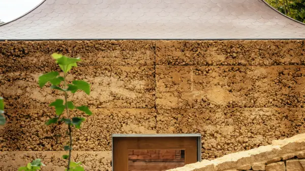 exterior of building with rammed earth texture and top of doorframe